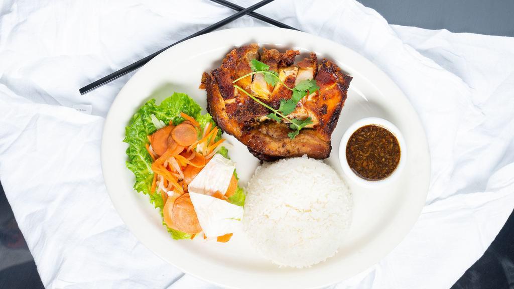 Golden Fried Chicken · Co'm gà chiên. Marinated, battered and fried boneless leg quarter, served with garlic shallot soy sauce, jasmine rice, and salad.