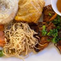 Combo Rice · Co'm đặc biệt. Grilled bone-in marinated pork chop, fried eggs, bean curd skin, salad, and j...