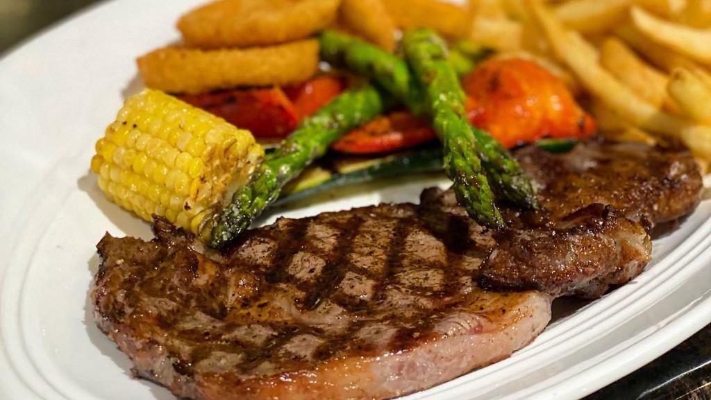 Filete New York · Con papas fritas or vegetables asados grilled steak served with your choice of French fries or grilled veggies.