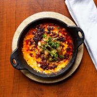 Queso Fundido · Hot melted cheese topped with chorizo or poblano peppers and pico de gallo, corn or flour to...