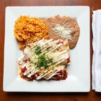 Enchiladas Suizas · 3 enchiladas filled with roasted poblano strips w/ cheese, chicken tinga or beef topped with...