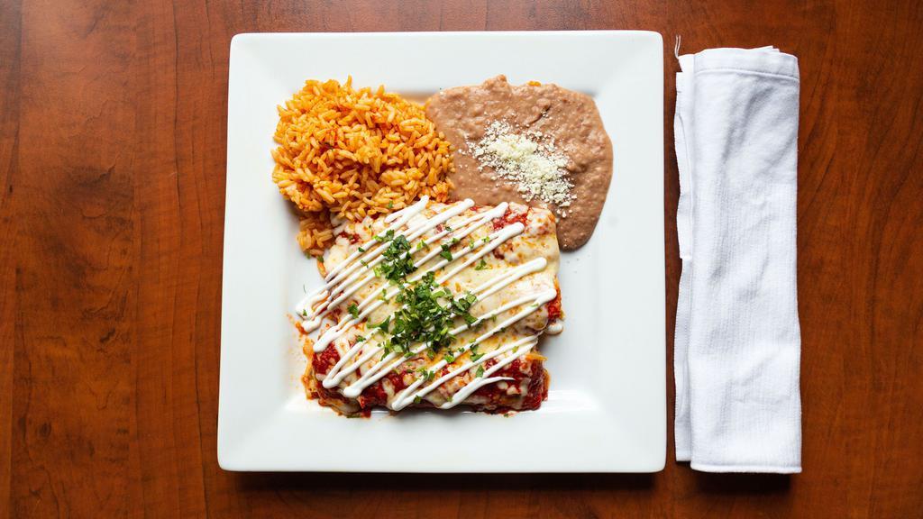 Enchiladas Suizas · 3 enchiladas filled with roasted poblano strips w/ cheese, chicken tinga or beef topped with salsa roja or salsa verde(*SPICY*) and melted cheese, side of rice and beans