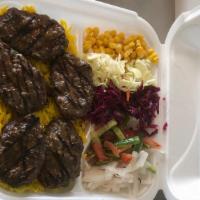 Kifta Kabab · Grilled ground beef served with rice and salad.