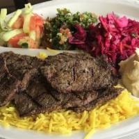 Shish Kabab · Grilled tender beef served with rice and salad.