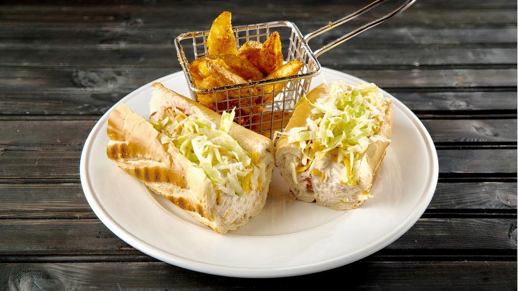 Tuna Baguette · Longfin tuna tossed in mayo, lemon, and celery. Served with tomatoes, and celery. Served with tomatoes, jack and cheddar cheese and shredded lettuce.