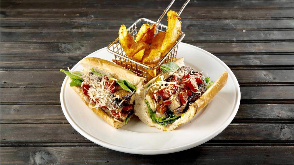 Philly Bello Baguette · Portobello mushrooms and fire-roasted red peppers sautéed in pesto oil, with baby spinach and shredded Parmesan cheese.