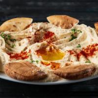 Hommous · Our famous family recipe topped with parsley, paprika and olive oil.