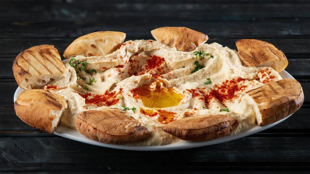 Hommous · Our famous family recipe topped with parsley, paprika and olive oil.