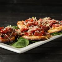 Bruschetta · Fire-roasted red peppers sautéed in pesto oil over baked garlic baguettes topped with baby s...