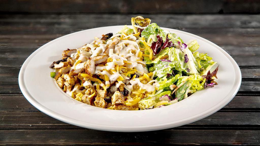 Newborn Chicken · Grilled chicken, sautéed portobello mushroom, green pepper and onion, served over a bed of warm basmati rice topped with jack and cheddar cheese, pesto ranch, and our house salad.