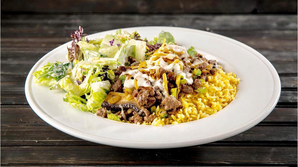 Steak Portobello · Grilled beef tenderloin, sautéed portobello mushroom, green pepper and onion. Served over a bed of warm basmati rice topped with jack and cheddar cheese, pesto ranch, steak sauce and our house salad.