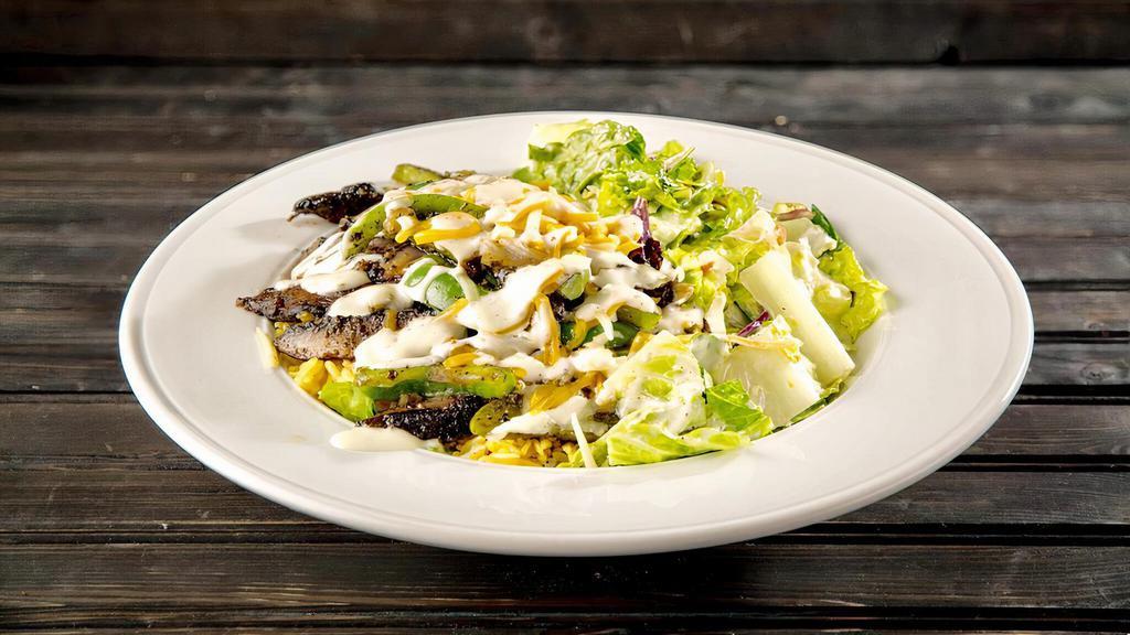 Newborn Veggie · Sautéed portobello mushroom, green pepper and onion. Served over a bed of warm basmati rice, topped with jack and cheddar cheese, pesto ranch and our house salad.