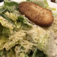 Caesar Salad · Romaine lettuce tossed in our Caesar dressing, croutons and topped with shredded Parmesan ch...