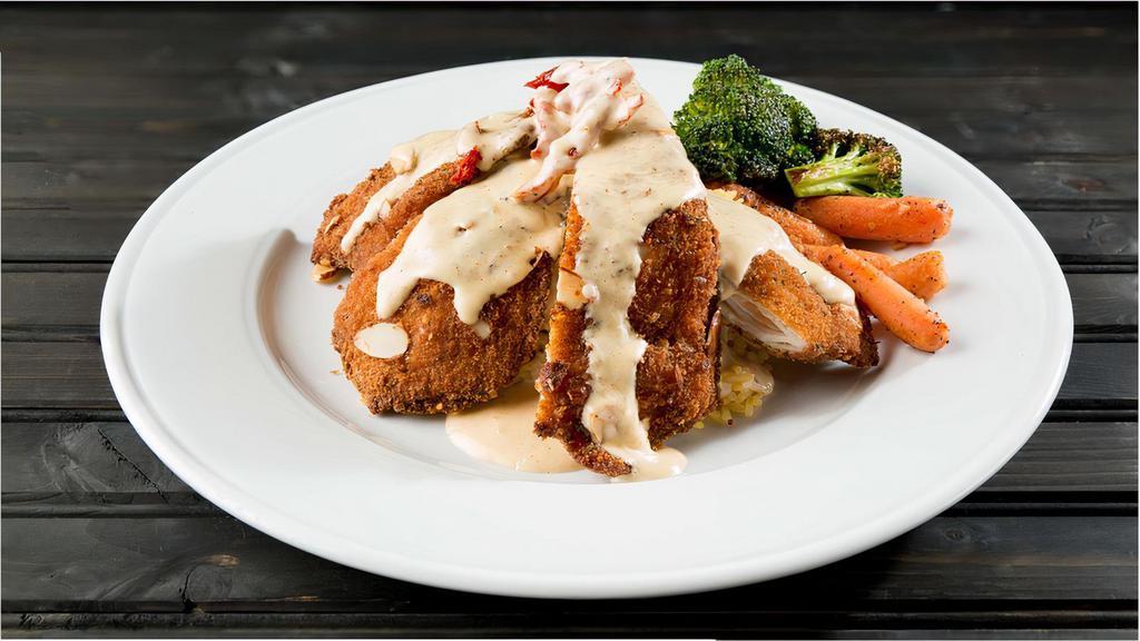 Almond Chicken · Chicken breast, breaded with thin almond slices, fried and served over warm basmati rice and vegetables. Topped with sun-dried tomatoes and house lemon cream sauce. Add chicken breast for an additional charge.