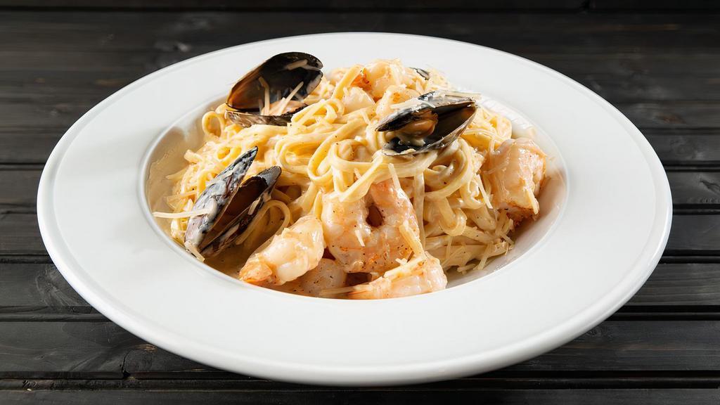 Penne Frutti Di Mare · Shrimp, scallops and mussels tossed with linguine noodles in your choice of our spicy marinara or lemon garlic cream sauce and topped with shredded Parmesan cheese.