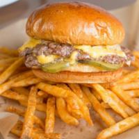 Classic Diner Cheeseburger · 502 thin all beef patties, American cheese, grilled onions, pickles, Dijon mayo, on a butter...