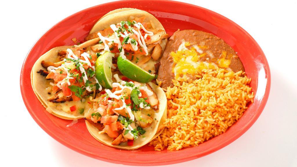 Mexico City Tacos · Three corn tortillas with your choice of chicken, steak or carnitas topped with cheese, onions, peppers, cilantro, pico de gallo and sour cream.