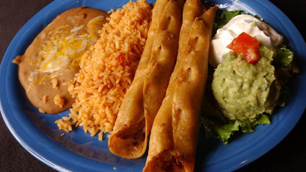 Flautas Platter · Two large corn tortillas rolled with fajita chicken, cheese and sour cream sauce. Fried to a golden brown and served with sour cream and guacamole.