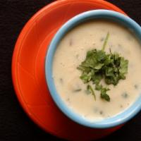 White Queso Los Cabos · Creamy Queso mixed with peppers, onions, cilantro and garlic