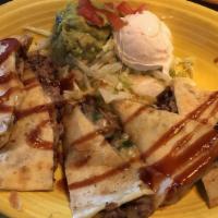 Brisket Quesadillas · Our slow-roasted brisket, onions, and peppers smothered between two flour tortillas with pep...
