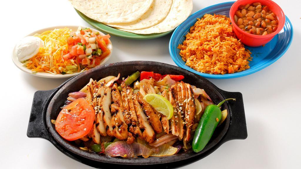Chicken Fajitas · Tender, marinated chicken breast blazed on the grill with bell peppers and onions.