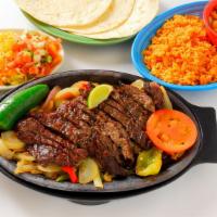 Steak Fajitas · Sizzling, seasoned skirt steak with grilled bell peppers and onions.