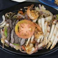 Fajita Trio · A combination of shrimp, chicken and steak fajitas served to you on a sizzling platter with ...