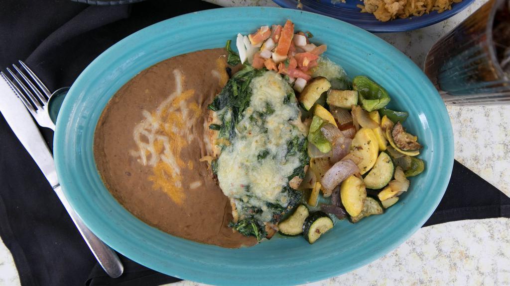 Roasted Garlic & Spinach Stuffed Chicken · A large, stuffed chicken breast topped with pepper jack and cotija cheese and served with grilled vegetables and your choice of refried, borracho or black beans.