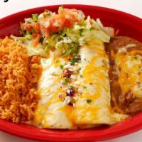 Fajita Chicken Enchiladas · Tender, diced marinated chicken breast rolled into two flour tortillas and topped with homem...