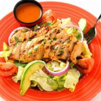 Tequila Lime Chicken Salad · Margarita-marinated chicken atop fresh greens with avocado, tomato, red onion, bacon, cotija...