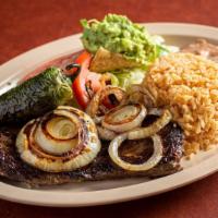 Carne Asada · U.S. choice steak / outer skirt served with delicious guacamole and grilled onion.