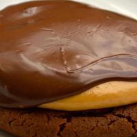 Buckeye · Chocolate cookie filled with our creamy peanut butter mixture, topped with guittard chocolate.