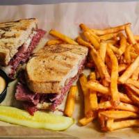 Reuben · Kbc made corned beef thinly sliced, swiss cheese, whole grain mustard kraut. Served on thick...