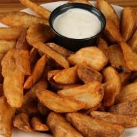 Wedge Steak Fries · Our tasty thick cut fries served with a side of ranch.  You'll love these fries!