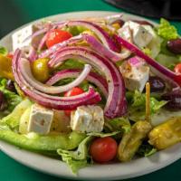 Greek Salad  · With romaine, green peppers, ripe tomatoes, cucumbers, red onions, black olives, pepperoncin...