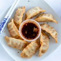Mandu · Beef pot stickers fried and served with a side of housemade soy dipping sauce.