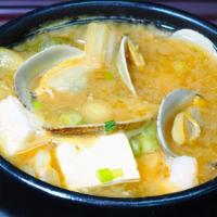 Haemul Doenjang Chigae · Shrimp, clam, tofu, scallions, zucchini, mushrooms, onions and jalapeño served boiling in a ...