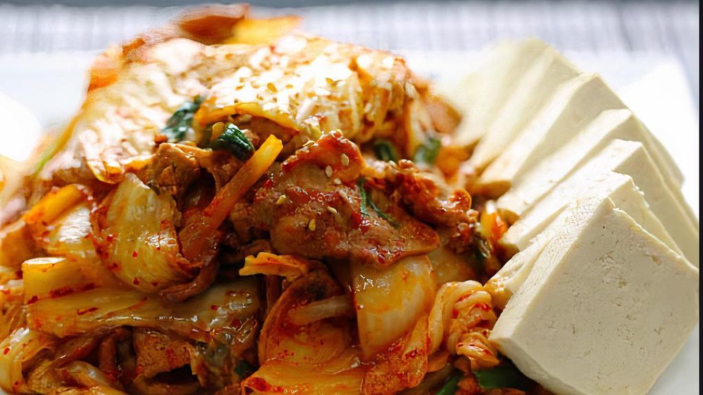 Kimchi Bokkeum · Pan fried pork, kimchi, rice cakes, scallions, onions and fresh slabs of tofu on the side.