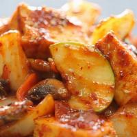 Dubu Bokkeum · Fried tofu cubes, zucchini, carrots, onions and mushrooms sautéed in a red chili sauce.