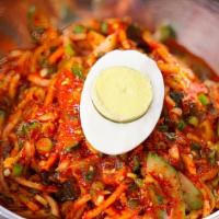 Bibim Naeng Myun · Pickled radish, cucumber slices, jalapenos, scallions and hard-boiled egg set atop a mound o...