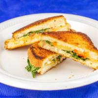 Grilled Cheese Delight · Havarti, Gouda, white Cheddar, pesto, sundried tomatoes and spinach.