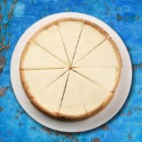 Cheese Cake Clasico · One slice of rich and creamy cheesecake baked on an all-butter short cookie crust.