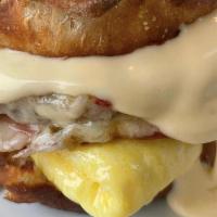 M40 Commuter Sandwich · Our signature breakfast handheld. Egg*,
sausage* patty, smoked ham*, pepper jack
cheese, hou...
