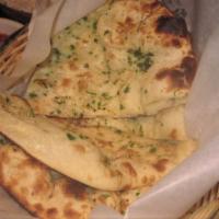 Garlic Naan · White flour hand tossed bread baked with garlic and cilantro