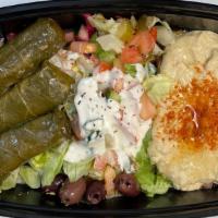 Vegetarian Grape Leaves Appetizer · Vegetarian. Three hand-rolled grape leaves stuffed with seasoned rice and green and yellow o...