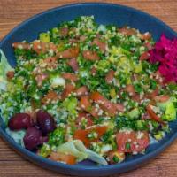 Tabouli Salad · Chopped tomatoes, green onions, parsley, bulgur, olive oil, lemon juice, and mint. Served wi...