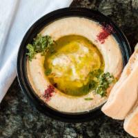 Large Humus · Blended chickpeas with tahini and lemon served with 2 piece pita bread.