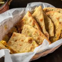 Spicy Naan · Spicy. Dairy and gluten. Flat leavened soft bread bake in the tandoori oven with chopped gre...