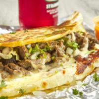 Carne Asada (Steak) Quesadilla · Flour tortilla, with shredded cheese and steak inside, served with a side of lettuce, pico d...