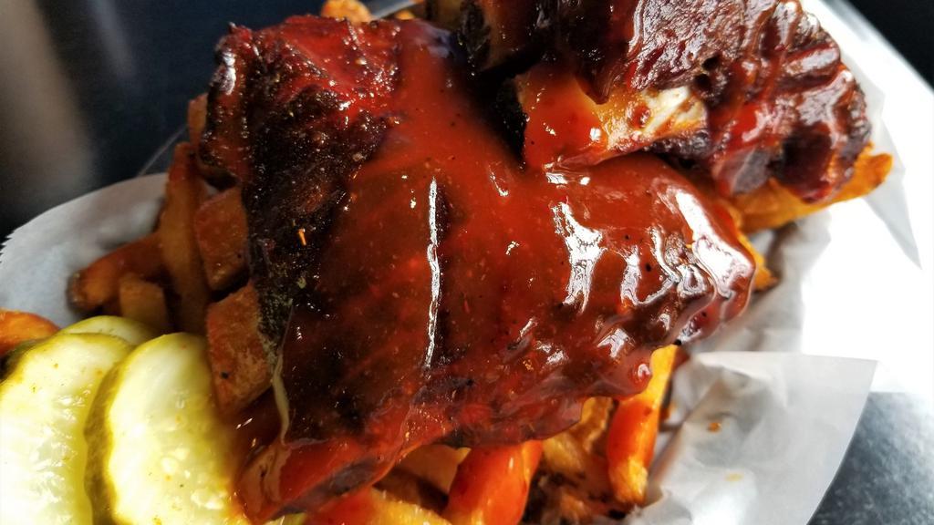 Firecracker Rib Bites · Low and slow smoked rib bites smothered with our new firecracker bbq sauce. Served over a basket of fries.